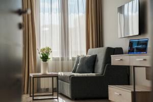 a living room with a chair and a window at Guest House Velik in Sandanski