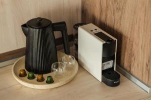 affeepot and a coffee maker sitting on a table at Guest House Velik in Sandanski +20 photos