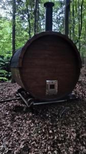 a wooden boat sitting on the ground in the woods at WisiLas Nad Sercowym Potokiem in Rabka-Zdrój