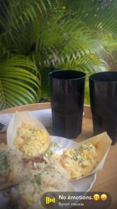 a plate with two slices of pizza on a table with two cups at Bulle skys evasion in Gros-Morne +27 photos