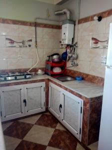 a kitchen with a sink and a counter top at Location près de la plage in Tichi