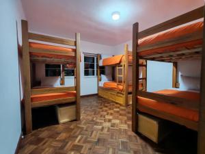 a room with three bunk beds in it at York Hostel in La Paz