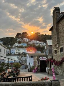 a view of a town with the sunset in the background at harbourways in Looe
