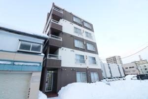 a building with snow in front of it at Maison Odori-Higashi building in Sapporo