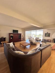a living room with a couch and a table at 95 on Acacia in Helderberg