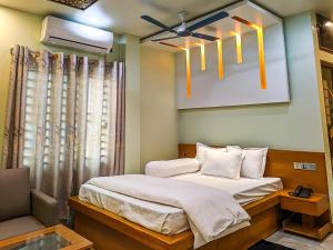 a bedroom with a bed and a ceiling fan at Mountain Springs Resort in Bāndarban