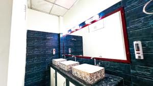 a bathroom with three sinks and a large window at Mountain Springs Resort in Bāndarban +38 photos