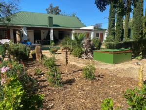 a garden in front of a house at Emma's Place in De Rust