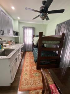 a kitchen with a couch and a ceiling fan at Must See Okemo Mountain Resort in Springfield