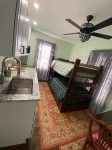 a kitchen with a sink and a bunk bed at Must See Okemo Mountain Resort in Springfield