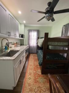 a kitchen with a couch and a ceiling fan at Must See Okemo Mountain Resort in Springfield