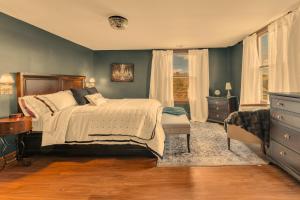 a bedroom with a bed and a dresser and window at The John Collins House in Canfield +33 photos