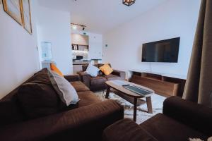 a living room with two couches and a tv at Shan's Comfort Sanctuary in Tatu City
