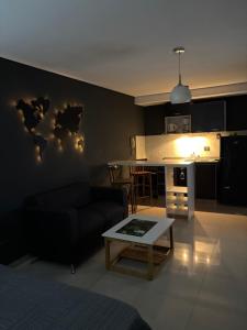 a living room with a couch and a table at Ballester apart piscina in Villa Ballester
