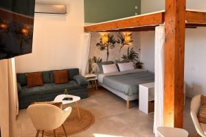 a living room with a bed and a couch at Le cocon près d'Albi in Saint-Grégoire