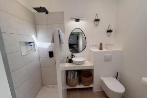 a white bathroom with a sink and a mirror at Le cocon près d'Albi in Saint-Grégoire
