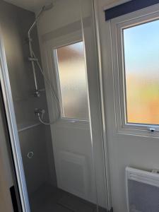 a bathroom with a shower and a window at Finca Leberto in Renesse +11 photos