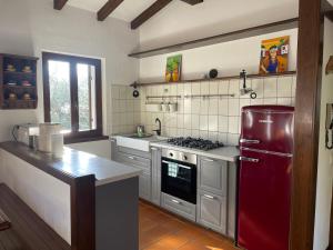 a kitchen with a red refrigerator and a stove at Etti's House in Malcesine