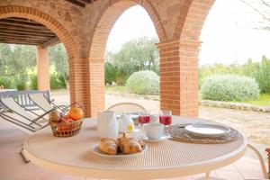 a table with food and drinks on a patio at Bio Agriturismo Le Cascatelle in Saturnia +46 photos