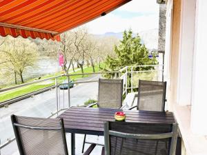 a table and chairs on a balcony with a view at Schöne Aussicht in Ediger-Eller