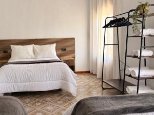 a bedroom with a white bed and a shelf at Villa 365 in La Rábita