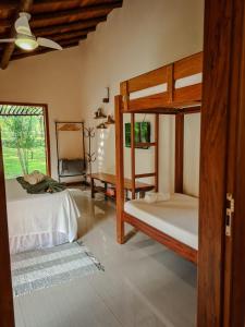 a bedroom with two bunk beds and a window at Villa Sana Maritacas in Sana +181 photos