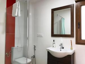 a bathroom with a sink and a toilet and a mirror at Alojamiento con terraza en Chulilla in Chulilla +13 photos