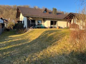 a house with a large lawn in front of it at Ferienhaus Natternberg Spacious apartment large living room 4 bedrooms garden quiet near Deggendorf in Deggendorf