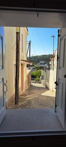 an open door of a building with a street at Oikos Filon in Palaiókastron