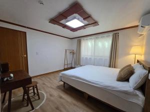 a bedroom with a bed and a table and a window at Wizday Stay in Suwon +20 photos