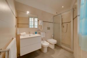 a bathroom with a sink and a toilet and a shower at Appartamenti - Villa Mare in Pomonte +183 photos
