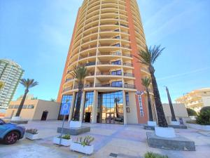 a tall building with palm trees in front of it at Da Rocha Beach 8, SEA VIEW in Portimão