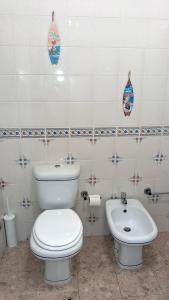 a bathroom with a toilet and a sink at Da Rocha Beach 8, SEA VIEW in Portimão +20 photos