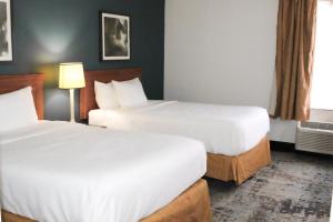 a hotel room with two beds and a window at La Quinta by Wyndham Lakeland East in Lakeland