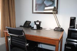 a desk with a telephone and a lamp on it at La Quinta by Wyndham Lakeland East in Lakeland +15 photos