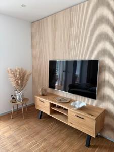 a living room with a flat screen tv on a wall at Ferienwohnung Bacchus in Bad Sulza
