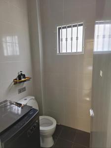 a small bathroom with a toilet and a window at Dirindu homestay in Temerloh +58 photos