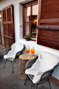 two chairs and a table with two glasses on it at Haus Sommerseit'n Ruhe-Natur-Genuss in Hirschbach +14 photos