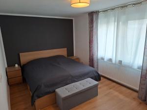 a bedroom with a bed and a large window at Ferienwohnung Am Anger in Unterleinach