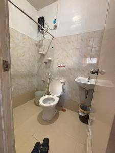 a bathroom with a toilet and a sink at Amalia Homes Staycation in Palo +7 photos