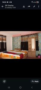 a hotel room with two beds and a mirror at Hotel Sangla Retreat in Sāngla
