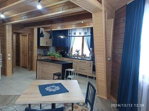 a kitchen and dining room with a table and chairs at Садиба Буквиця in Migovo