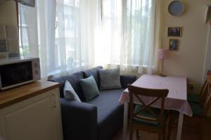a living room with a blue couch and a table at Our House In The Town in Veliko Tŭrnovo +29 photos