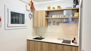 a kitchen with a sink and wooden cabinets at Behind On The Canalside Venice in Venice +20 photos