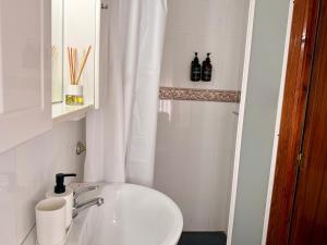 a white bathroom with a sink and a toilet at Villa 365 in La Rábita +7 photos