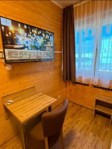 a wooden room with a table and a tv on the wall at URBAN OAK Smart Stay in Cologne +54 photos