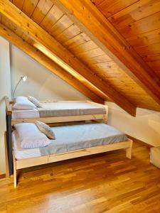 two bunk beds in a room with wooden ceilings at Casa Miradell in Hoz de Jaca