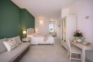a bedroom with a bed and a couch in a room at Isola Charm B&B - Pool & Nature Stay in Syracuse