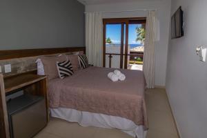 a bedroom with a bed with two towels on it at Terra Bella Pousada in Morro de São Paulo +116 photos