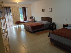 a living room with two beds and a room with at Hotel Pousada DV 360 in Dois Vizinhos +7 photos